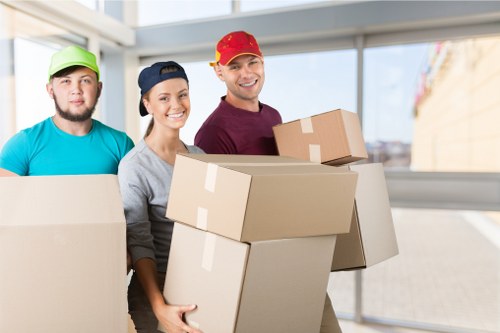 Removal team handling packed boxes with safety awareness