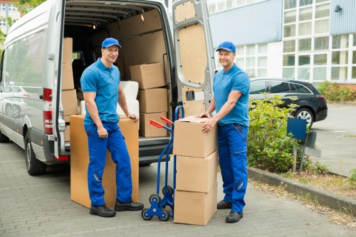 Organised moving process showing wrapped furniture and packed cartons